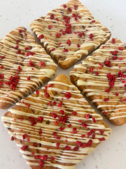White chocolate and raspberry cookies drizzled with white chocolate and topped with freeze dried raspberries
